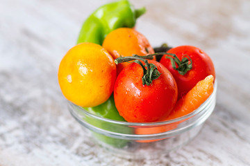 Fresh veteables in a bowl against potatoe chips