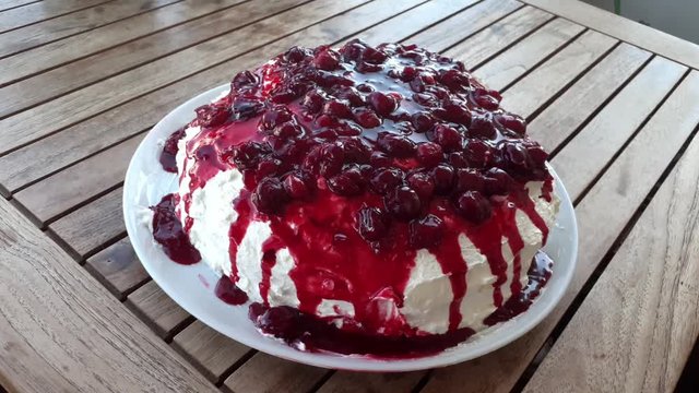 Zoom to home made sour cherry cake on the wooden table.