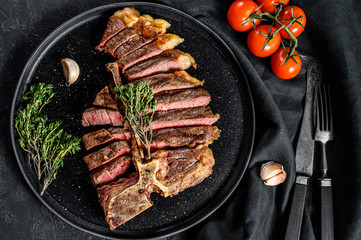 Grilled Porterhouse steak on a chopping Board. Cooked beef meat. White wooden background. Top view