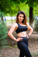 Fototapeta premium girl athlete in sports apparel in Park outdoors. fitness training outdoors.