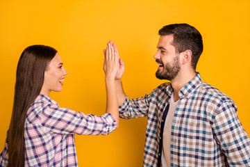 Profile side photo of excited spouses man woman take party sport match celebrate victory hold hand gesture high five wear good look outfit isolated over bright shine color background