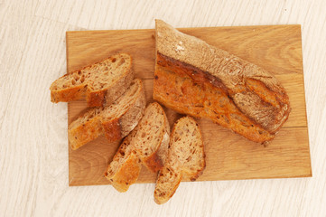 French buckwheat loafs sliced into pieces on a wooden board