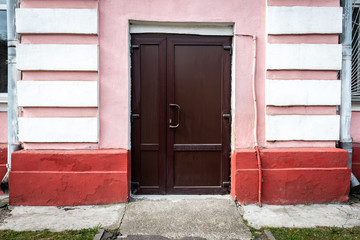 Outside door to the pink building.