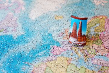 Tourist attractions and souvenir of bologna italy on world map background of puzzle for travelers. Copy space