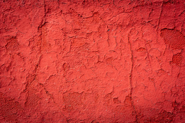 Red old cracked concrete wall background or texture.