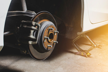 Disc brakes and calipers original system of car and wheels were uninstalled for maintenance.