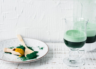 Obraz na płótnie Canvas Healthy green vegan smoothie with spirulina and turmeric for detoxification. Spirulina smoothie.