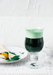 Healthy green vegan smoothie with spirulina and turmeric for detoxification. Spirulina smoothie.