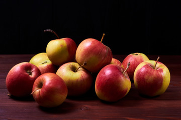 Fresh red-green apples on a wooden background.