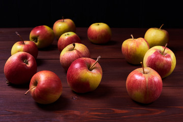 Fresh red-green apples on a wooden background.