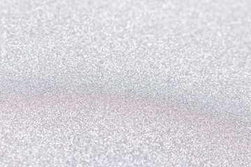 Silver glitter texture background. Shiny defocused backdrop.