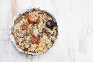 rice with duck and smoked sausages in plastic box