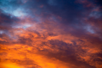Naklejka na ściany i meble Colorful image of dramatic cloudscape. Amazing clouds of pink, red, violet, gray color on the background of the evening dark sky after sunset.