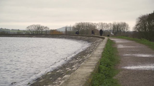 Few people walking around in cheddar reservoir, Somerset, United Kingdom.