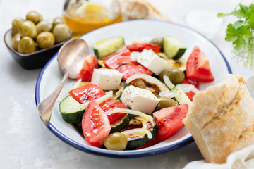 salad with fresh and grilled salad on white dish on gray ceramic background