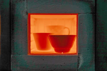 Firing of products in the pottery. Ceramic bowls.