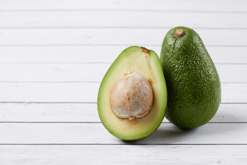 Avocado on wooden background. Top view. Free space for your text.