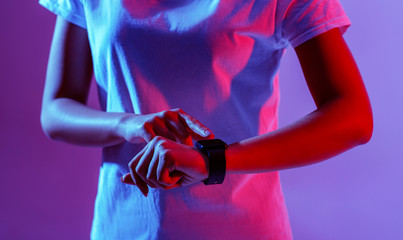 Millennials with device. Smartwatch on girl hand, cropped