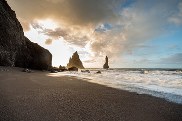 The black sand beach of Reynisfjara and basalt rock formations Troll toes in the southern coast of...
