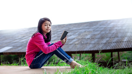 Asia girl sitting and reading the Bible. Christian concept. © surachat