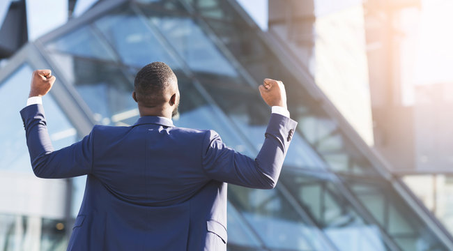 Businessman Shaking Fists Standing Back To Camera Celebrating Success Outdoors