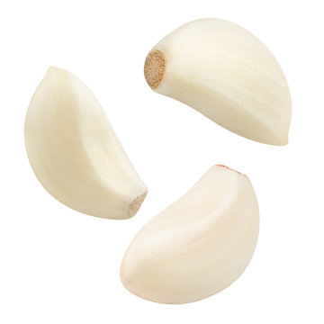 Flying garlic cloves, isolated on white background