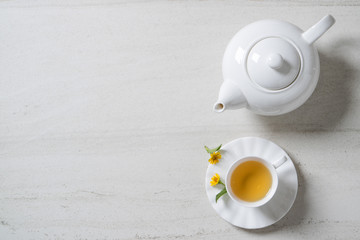 Top view a cup of tea on white stone desk. Free space for your text.