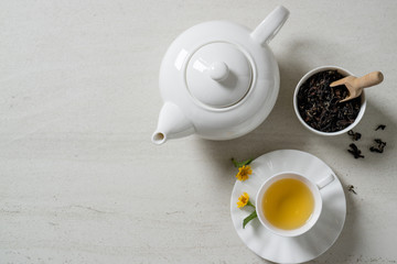 Top view a cup of tea on white stone desk. Free space for your text.