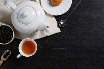 Organic tea on the black stone background with a space for text.