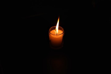 burning candle in the dark