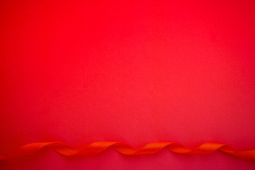 Red paper with red satin ribbon, Love or Gift background	