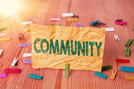 Conceptual hand writing showing Community. Concept meaning specific population with a common characteristics living together