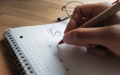 hand with pen and notebook