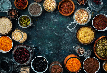 Zero waste and sustainable lifestyle. Plastic free storage and cooking concept. Various organic superfoods, beans, grains, cereals, legumes, seeds in reusable cans and jars.