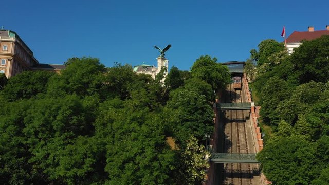 Drone goes slowly forward and up at the Budapest Castle Hill Funicular and the Turul Bird statue