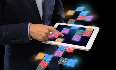Entrepreneur using functional interface of tablet computer on black background, collage with different web icons