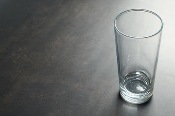 empty tall glass cup on a dark background