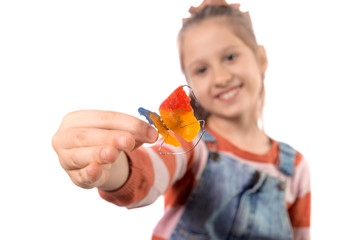 Little girl with orthodontics appliance isolated on white background.