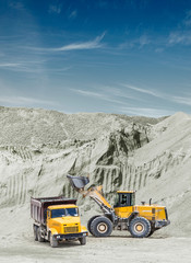 Excavator and truck in the quarry