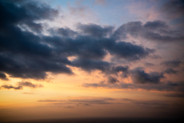 Naklejka na ściany i meble Colorful dawn / dusk sky with dark clouds