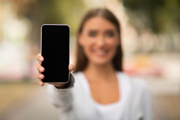 Unrecognizable Woman Showing Cellphone Empty Screen Standing Outdoor, Mockup