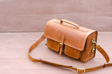Old brown leather luggage with wood background