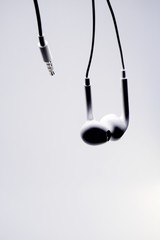 Silhouette of an earphone with white background.