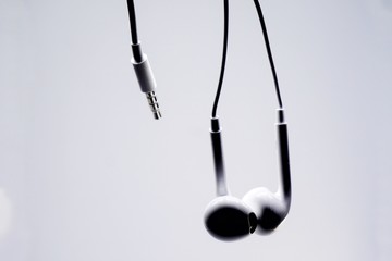 Silhouette of an earphone with white background.