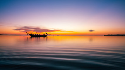 Silhouette of sunset time with fishing Long tail boats (Traditional boats) on the sea at Wok tum beach Phangan island,Thailand