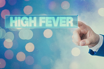 Writing note showing High Fever. Business concept for medical condition which the body temperature...