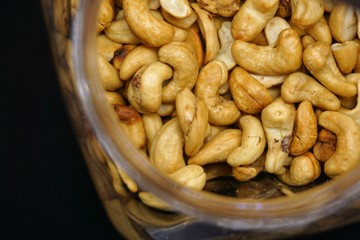 close up of cashew nuts with black background.