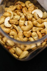close up of cashew nuts with black background.
