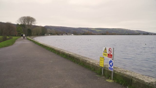 Few people walking around in the foot path of the cheddar reservoir, Somerset, United Kingdom.