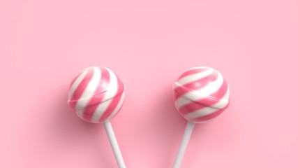 Two sweet striped pink and white lollipops on stick on bright pink background. 3d rendering